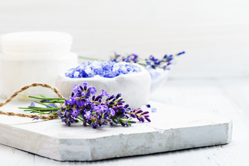 ingredients for lavender spa, flower and salt on white wooden background.