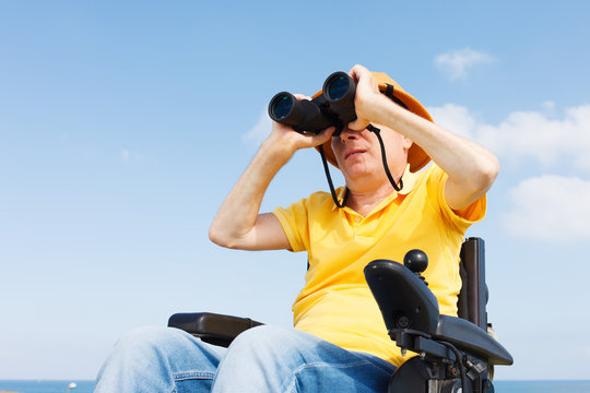 Disabled man with binocular.