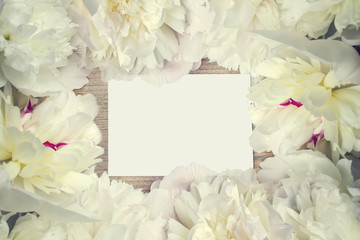 Lush frame of white peony flowers with note for congratulations. Flower postcard