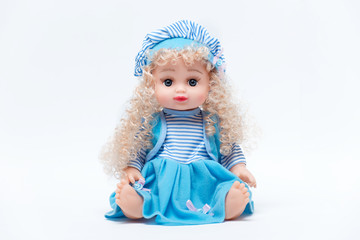 Beautiful baby doll with blond hair in blue dress isolated on white background