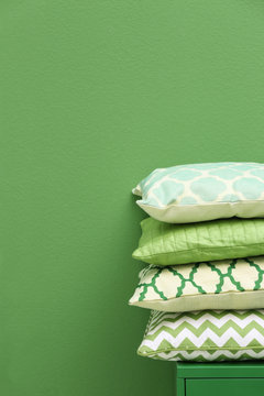 Stack of pillows on green background