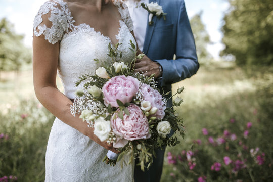 bride and groom holding bouquet