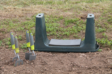 A Gardening Kneeling Pad with Two Trowels and Forks.