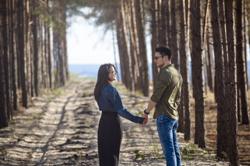 Fototapeta premium Happy couple walking in the forest. Love story