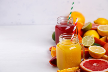 Juices Fresh Orange and Citrus on a White Background.Healthy Beverage.Food or Healthy diet concept.Mixed Colorful Tropical Background.Copy space for Text. selective focus