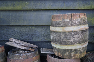 Fototapeta premium Wooden barrels and wall on background, outdoors