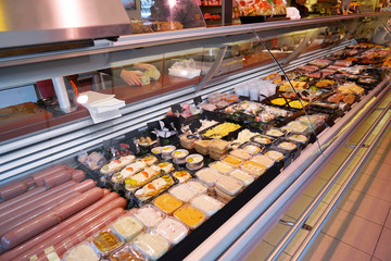 Showcase with different food in supermarket