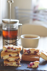 Tea, brewer and pie in berries for breakfast, bright lighting from the window, vertical