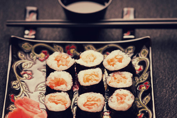 Sushi rolls with salmon, chopsticks and soy sauce 