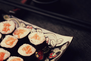Sushi rolls with salmon and chopsticks