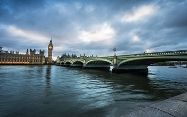 Big Ben and Westminster bridge in London at dusk.