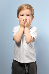 Cute little boy on color background