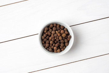 Allspice in white bowl. Close up
