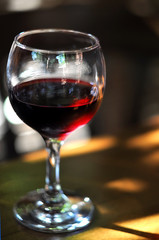 glass of red wine on the table in restaurant interior