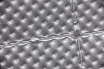 Microscopic close up of perforated pill package, abstract background image.