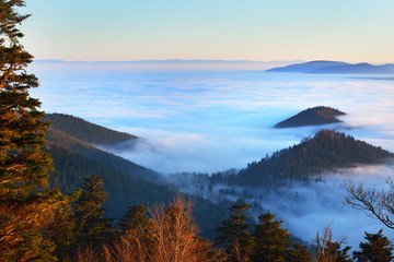 Beautiful view of a sunset in the mountains from the forest. French Alsace, Vosges mountains