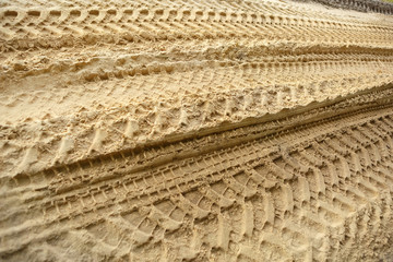 Tire tracks on the sand. Trace of wheels on the sand