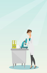 Laboratory assistant with a microscope.