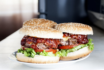 Three hamburgers in the kitchen