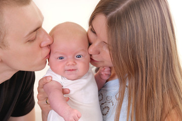 Closeup portrait of beautiful young family with newborn