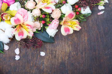 Flowers frame on wooden background