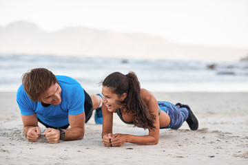Fototapeta premium Attractive Couple having fun Doing Planking Exercise