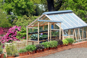 Greenhouse or hothouse set in a well maintained garden