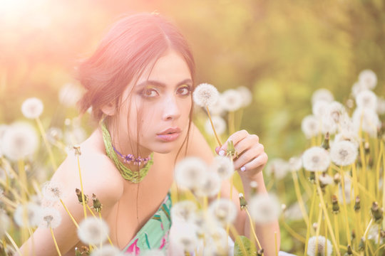dandelion field and pretty girl with fashionable makeup