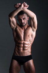 Fototapeta na wymiar muscular man with muscle torso in studio, sport and training