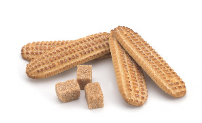 Biscuits, cane sugar, cinnamon sticks on white background