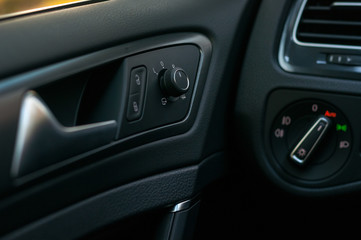 Fototapeta na wymiar Car interior: door, handle,mirror control.
