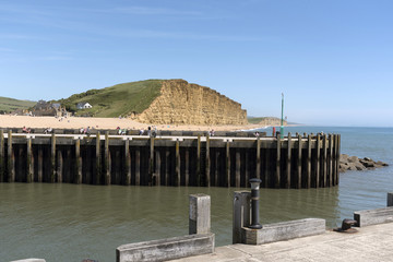 The Jurassic coastline viewed from the harbour entrance at West Bay in West Dorset England UK. June...