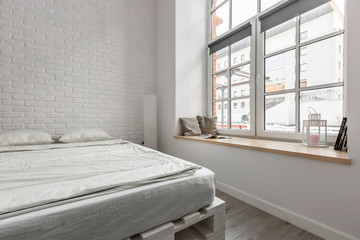 Loft bedroom with brick wall