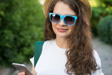 Girl traveler using smartphone on street