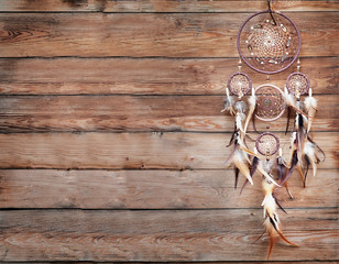   Dreamcatcher, american native amulet on wooden background. Shaman © Elina Leonova