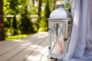 Wooden candlestick with white candles on beige cloth background