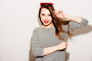High fashion look.glamor stylish beautiful young happy smiling woman model with red lips and red sunglasses