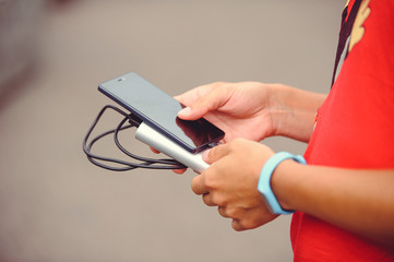 power bank charges the phone in its hands