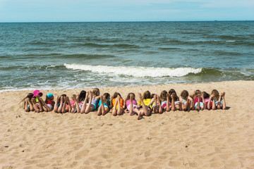 Group of children laying on beach