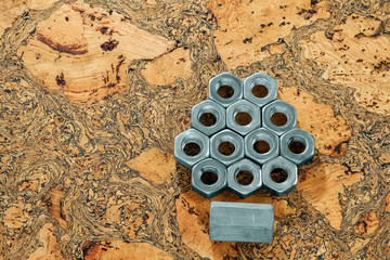 Metal nut on wooden background