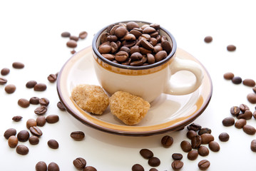 Coffee beans in a cup and sugar