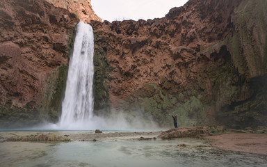 Backpacker taking in the beauty of Mooney Falls Grand Canyon Arizona