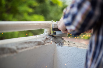 Master, cutting metal grinder, sparks everywhere, high speed rotating grinding wheels