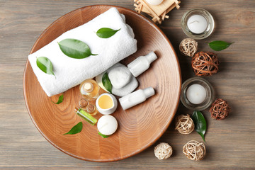 Spa composition with tea tree oil on wooden background