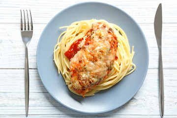 Delicious pasta with chicken parmesan and sauce on plate