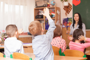 Boys raised hand in class