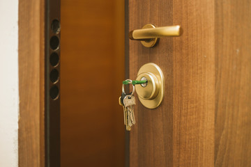 Obraz premium The keys in the lock of the door, on the outside, safety, locked doors, security, privacy