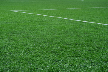 football field with artificial turf with white diagonal lines, background