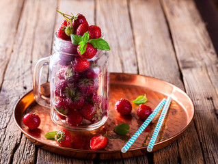 Fresh Strawberries in a glass Jar for Drinks on Vintage wooden background.Food or Healthy diet concept.Vegetarian.Copy space for text. selective focus