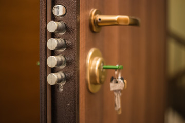 The keys in the lock of the door, on the outside, safety, locked doors, security, privacy